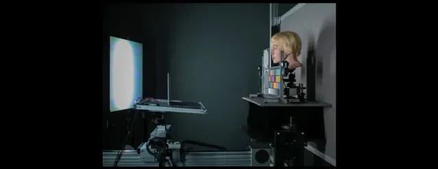 A side view of a photography setup featuring a mannequin head and color chart.