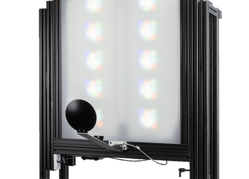 A large rectangular screen with multiple colorful narrow band light patterns, attached to a black metal frame and stand
